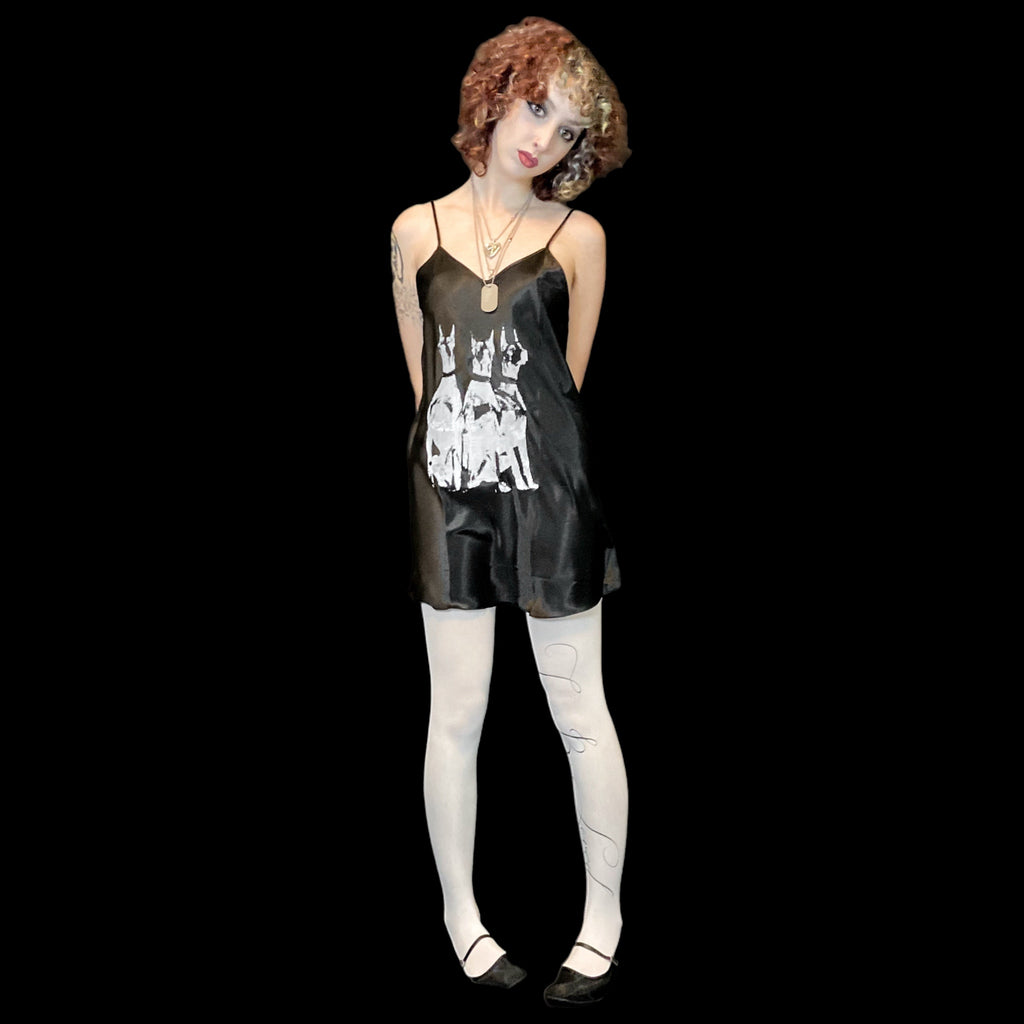 Woman wearing a black dress with a white graphic design on a black background