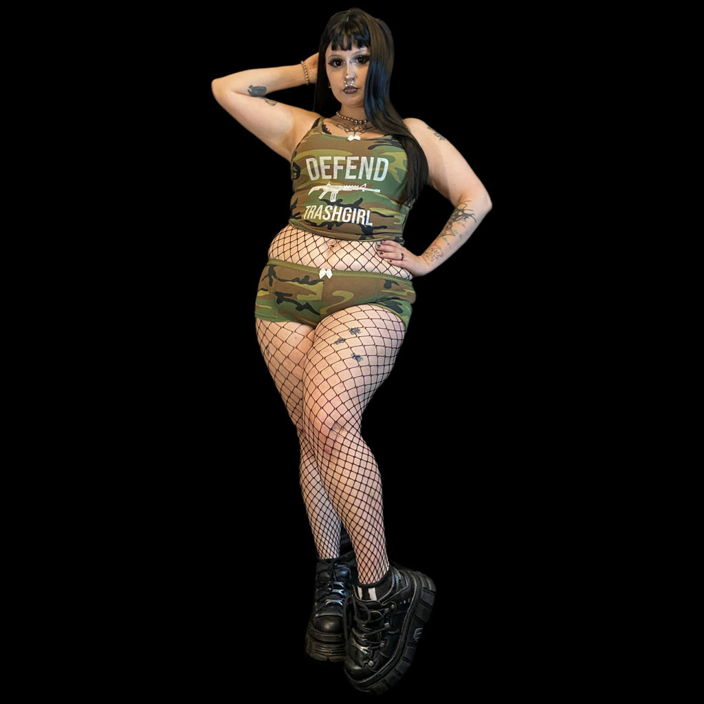 Person wearing a camouflage outfit with 'DEFEND' text on a black background