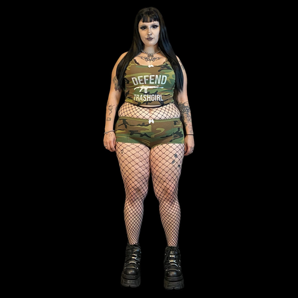 Person wearing a green camouflage outfit with text on a black background