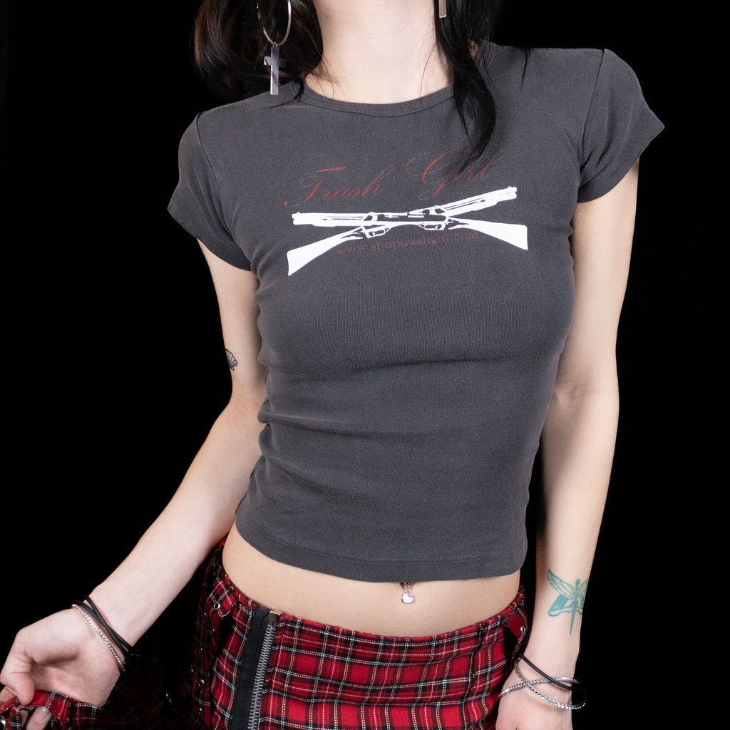 Person wearing a dark gray t-shirt with a graphic design on a black background