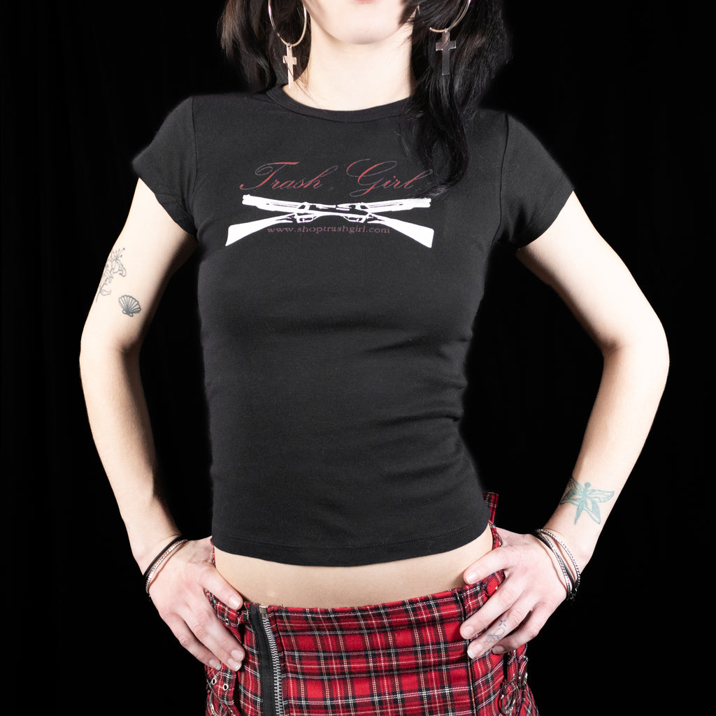 Person wearing a black t-shirt with 'Trash Girl' design on a black background