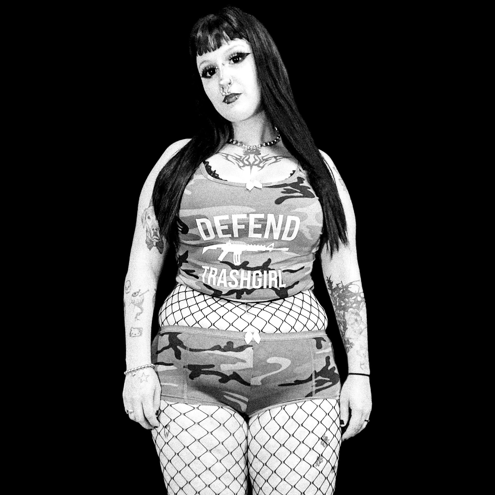 Black and white photo of a person wearing a tank top with text and camouflage design.